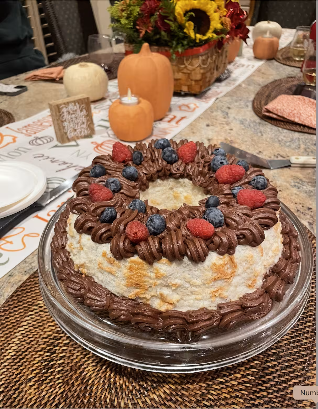 Angel food cake with chocolate frosting and fresh berries