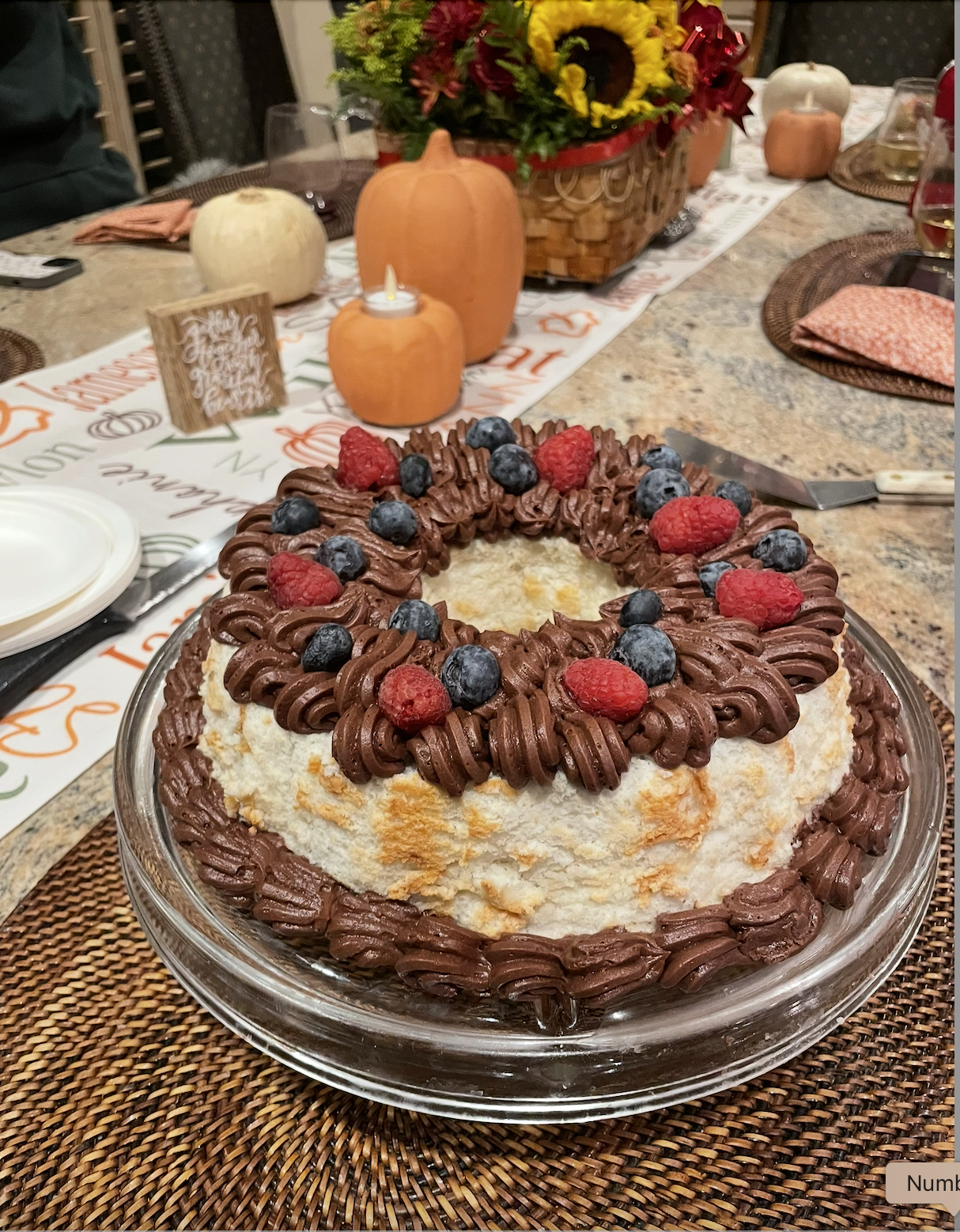 Angel food cake with chocolate frosting and fresh berries