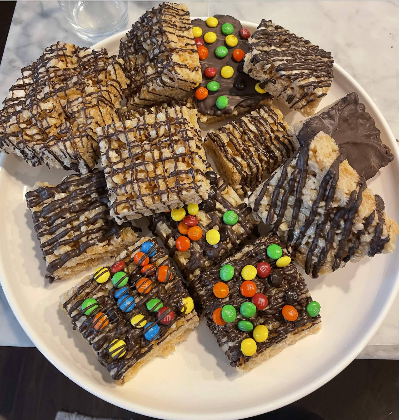 Rice krispie treats with chocolate drizzle and M&M toppings
